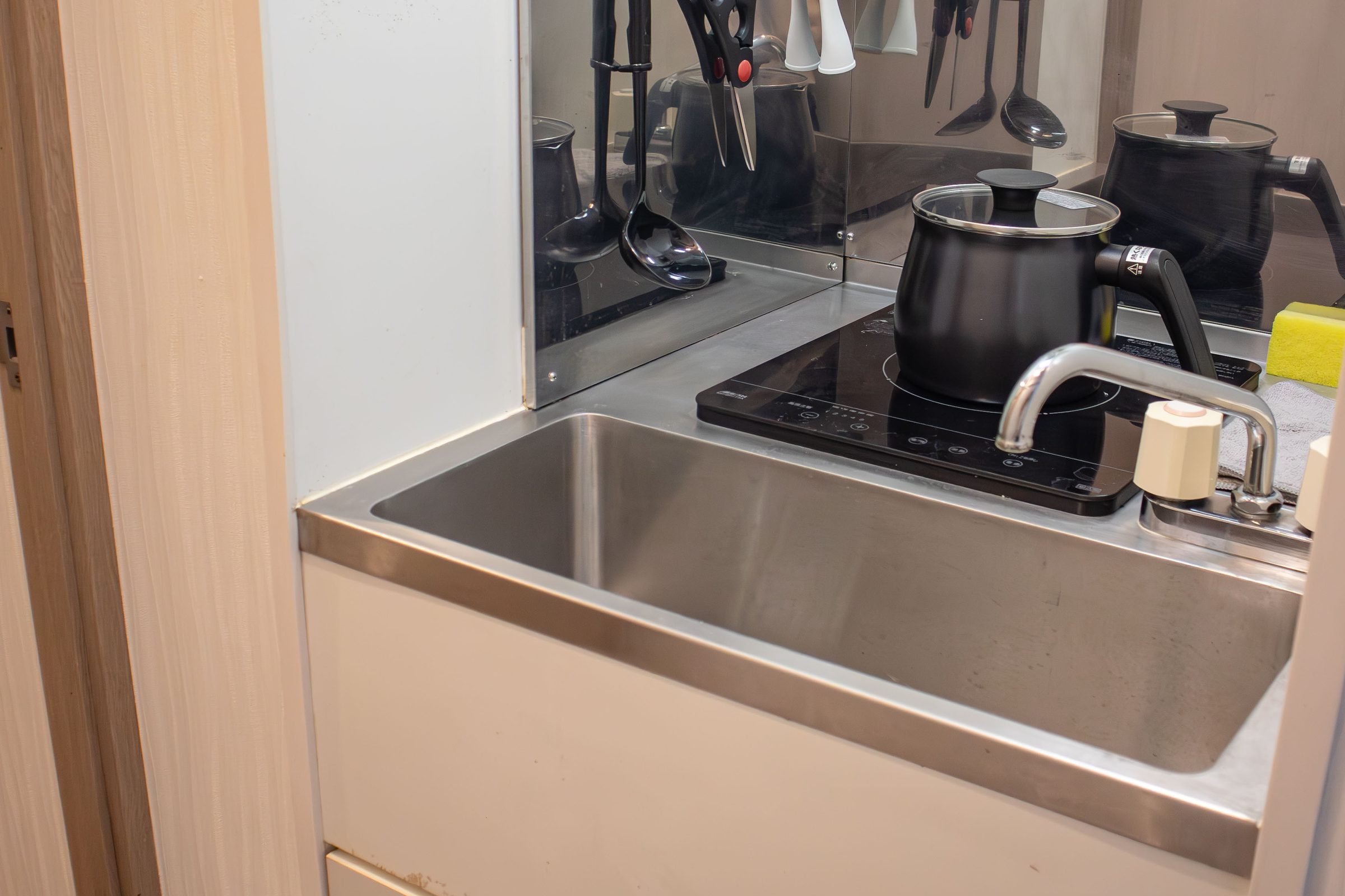 Small kitchen with sink, gas hob and mini fridge