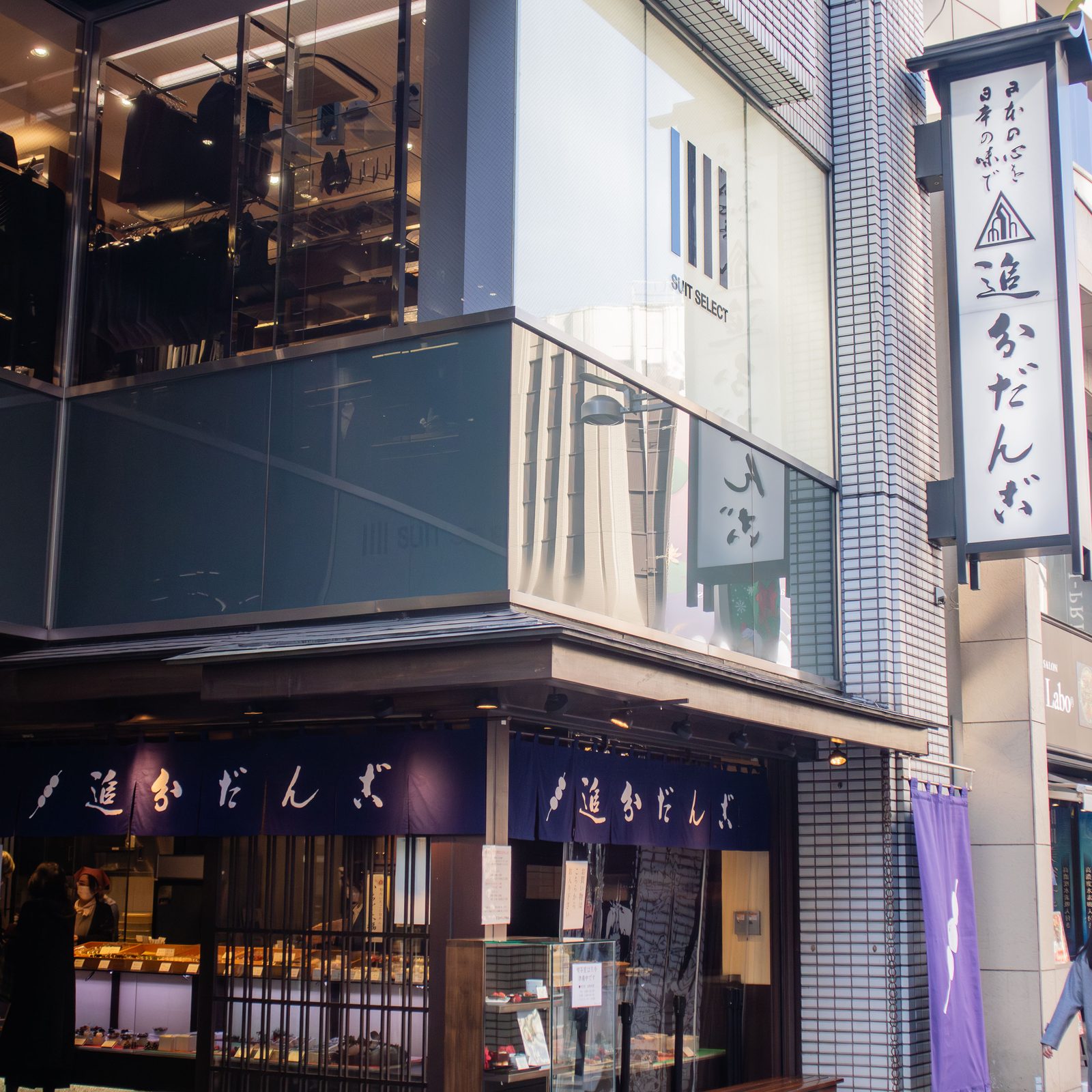 Street view of a traditional Japanese storefront in a city.