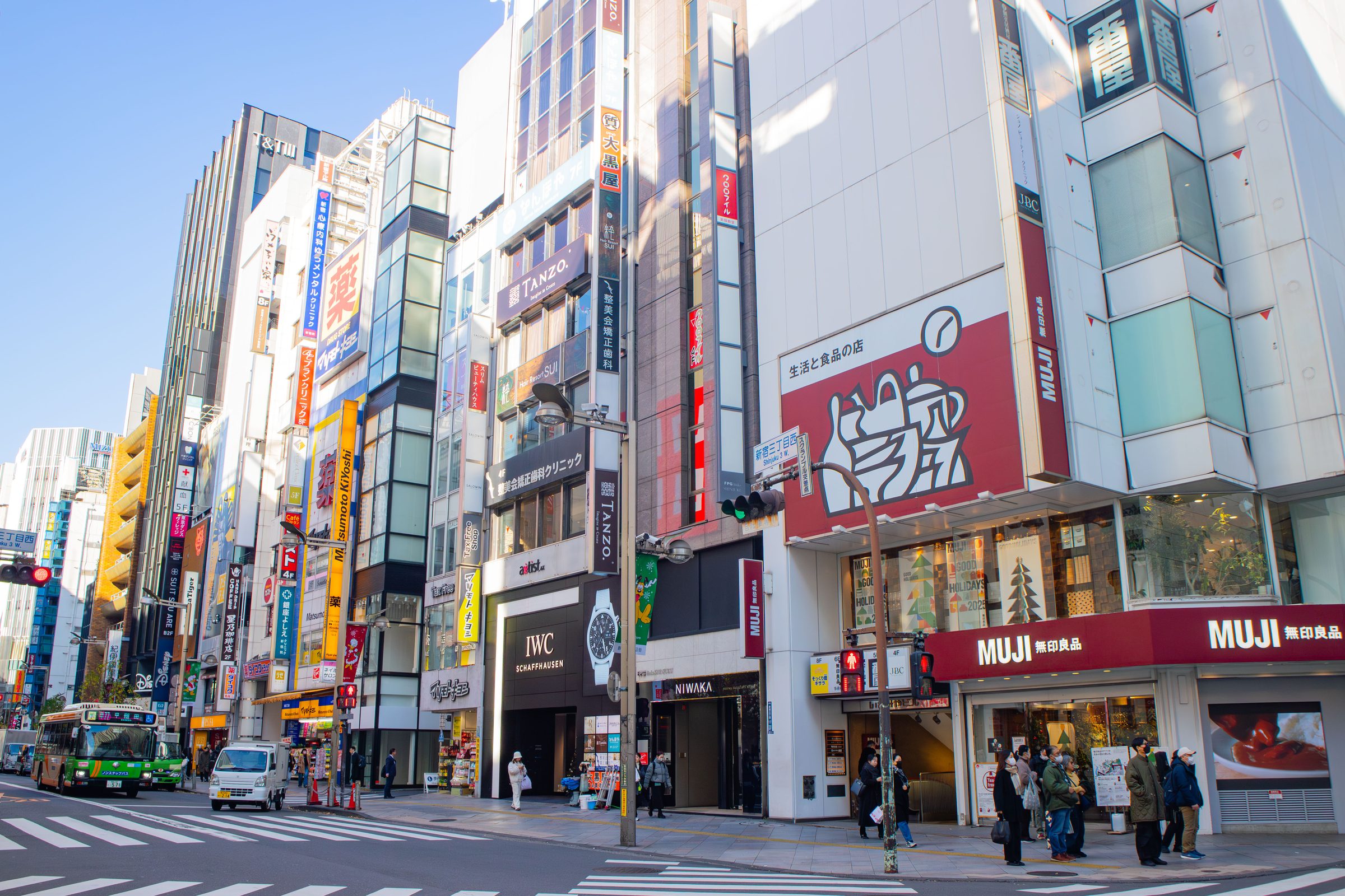 Busy street with shops and buildings in a Japanese city.